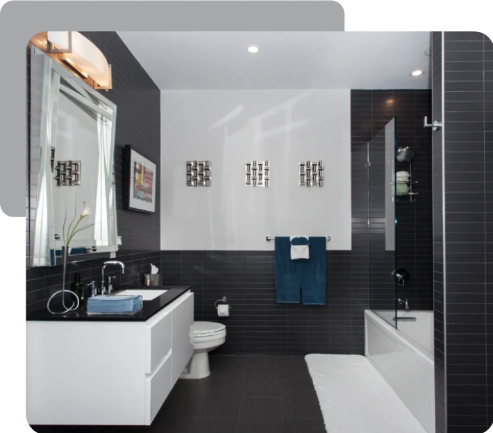 A bathroom with black and white tiles, a toilet and sink.